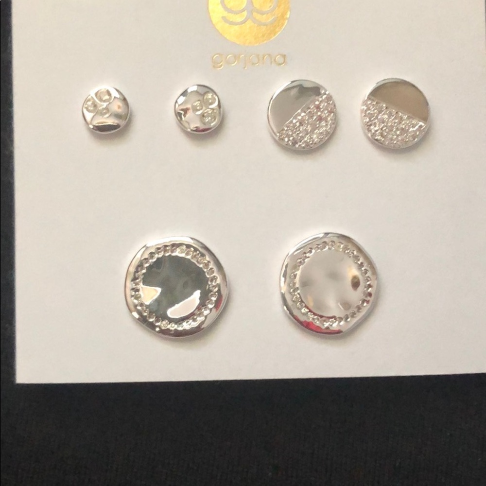 Silver earrings with rhinestone detail.